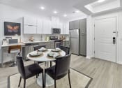 Thumbnail 49 of 80 - a kitchen and dining room with a table and chairs