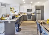 Thumbnail 64 of 80 - a kitchen and dining room with stainless steel appliances and a table