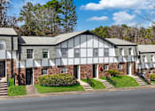Thumbnail 21 of 22 - A row of houses with white and grey facades.