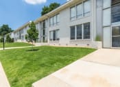 Thumbnail 17 of 18 - the front of a white building with a lawn and grass
