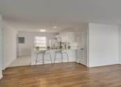 Thumbnail 14 of 18 - an empty living room and kitchen with a white
