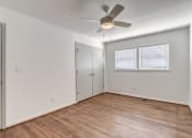 Thumbnail 10 of 18 - an empty living room with a ceiling fan and a closet