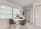 Thumbnail 4 of 18 - a dining room with a table and chairs