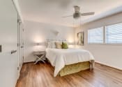 Thumbnail 7 of 18 - a bedroom with a bed and a ceiling fan
