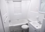 Thumbnail 5 of 12 - A white bathroom with a black and white checkered floor.