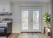 Thumbnail 5 of 22 - A kitchen with a black oven and white cabinets.