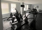 Thumbnail 23 of 28 - a room filled with lots of exercise equipment