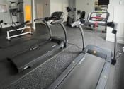 Thumbnail 24 of 28 - a gym with treadmills and other exercise equipment