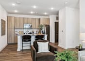 Thumbnail 32 of 46 - A modern kitchen with a dining area and a living room.at The Liliana Apartment Homes, Pooler, GA 31322