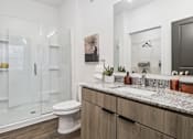 Thumbnail 38 of 46 - A modern bathroom with a white toilet and a marble countertop.at The Liliana Apartment Homes, Pooler, GA 31322