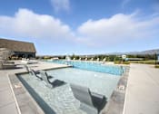 Thumbnail 46 of 59 - A large outdoor swimming pool with a sun lounger at The Garrison Luxury Apartment Homes, Fountain, CO 80817
