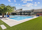 Thumbnail 12 of 46 - Pool With Lounge Chairs at The Liliana Apartment Homes, Pooler