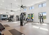 Thumbnail 16 of 46 - A spacious gym with a variety of equipment at The Liliana Apartment Homes, Pooler Georgia