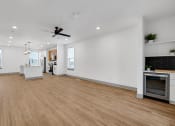 Thumbnail 19 of 58 - a large room with a wooden floor and a clock on the wall at Meridian at CityPlace, Woodbury, 55125