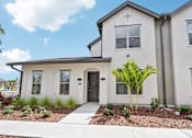 Thumbnail 2 of 43 - A white house with a black door and windows. at The Hadley - North Port, FL Apartments, North Port, Florida