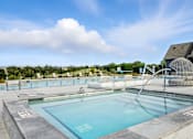 Thumbnail 42 of 59 - A large outdoor swimming pool with a slide at The Garrison Luxury Apartment Homes, Fountain, CO 80817