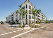 Thumbnail 3 of 57 - A large building with a parking at The Stadler Luxury Apartments, Bradenton, FL