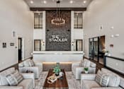 Thumbnail 47 of 57 - A modern living room with a chandelier at The Stadler Luxury Apartments, Bradenton, FL