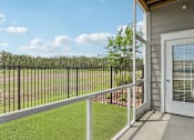 Thumbnail 56 of 124 - Covered balcony with artificial turf and pond views at Velara Luxury Apartments, Ponte Vedra Beach, 32081