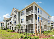 Thumbnail 1 of 124 - Three story apartment building with balconies and landscaping at Velara Luxury Apartments, Ponte Vedra Beach