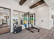 Thumbnail 46 of 57 - A gym with a weight rack, bench, and weights at The Stadler Luxury Apartments, Bradenton, FL 34210