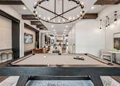Thumbnail 9 of 57 - A pool table is in the middle of a room at The Stadler Luxury Apartments, Bradenton, Florida