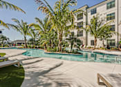 Thumbnail 5 of 57 - A pool surrounded by palm trees at The Stadler Luxury Apartments, Florida