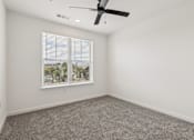 Thumbnail 54 of 62 - A room with a ceiling fan and a window with blinds.
