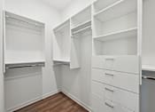 Thumbnail 56 of 60 - A white closet with drawers and shelves.