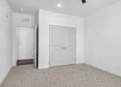 Thumbnail 69 of 124 - Empty bedroom with carpet and double closet doors at Velara Luxury Apartments, Florida, 32081