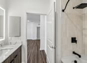 Thumbnail 77 of 124 - Bathroom with tiled shower and dual vanity at Velara Luxury Apartments, Ponte Vedra Beach, 32081