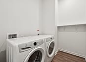 Thumbnail 55 of 60 - A white washing machine and dryer in a laundry room.