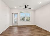 Thumbnail 76 of 124 - Spacious empty room with wood flooring and door at Velara Luxury Apartments, Ponte Vedra Beach, 32081