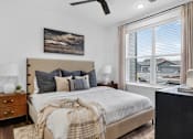 Thumbnail 11 of 44 - A bedroom with a large bed and a painting on the wall.at The Logan Luxury Apartments, Nampa, ID, 83651