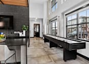 Thumbnail 33 of 44 - A modern kitchen with a black countertop and a long black table.at The Logan Luxury Apartments, Nampa, ID, 83651