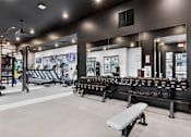 Thumbnail 25 of 44 - A gym with a variety of equipment including weights and a bench.at The Logan Luxury Apartments, Nampa, ID, 83651