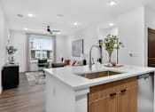 Thumbnail 9 of 44 - A modern kitchen with a large island and a dining area with a view of the city.at The Logan Luxury Apartments, Nampa, ID, 83651