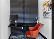 Thumbnail 35 of 44 - A red chair sits in front of a black desk with a computer on it.at The Logan Luxury Apartments, Nampa, ID, 83651