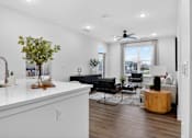 Thumbnail 8 of 44 - A living room with a white countertop and a black couch.at The Logan Luxury Apartments, Nampa, ID, 83651