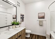 Thumbnail 13 of 124 - Bathroom with white vanity and walk-in shower at Velara Luxury Apartments, Florida, 32081