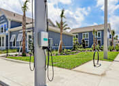 Thumbnail 98 of 124 - Electric vehicle charging stations with residential buildings at Velara Luxury Apartments, Florida, 32081