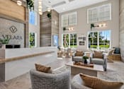 Thumbnail 112 of 124 - High ceiling lobby with modern seating and reception desk at Velara Luxury Apartments, Ponte Vedra Beach