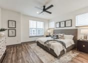 Thumbnail 14 of 58 - the master bedroom in a new home with a large bed and a ceiling fan at Meridian at CityPlace, Woodbury Minnesota