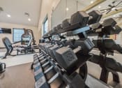 Thumbnail 34 of 45 - a gym with dumbbells and other exercise equipment at The BLVD at Wilson Crossings, Michigan, 49418