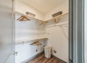 Thumbnail 20 of 45 - a walk in closet with shelves and a trash can in a room with a door at The BLVD at Wilson Crossings, Wyoming, MI 49418