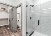 Thumbnail 9 of 58 - a white bathroom with a shower and a toilet at Meridian at CityPlace, Minnesota