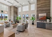 Thumbnail 113 of 124 - Clubhouse lobby with seating and wood accent wall at Velara Luxury Apartments, Florida, 32081