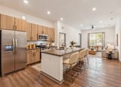 Thumbnail 64 of 65 - A modern kitchen with wooden cabinets and a stainless steel refrigerator.