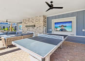 Thumbnail 102 of 124 - Covered outdoor entertainment space with ping pong table at Velara Luxury Apartments, Ponte Vedra Beach, Florida