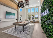 Thumbnail 91 of 124 - Game room with pool table and living wall accent at Velara Luxury Apartments, Ponte Vedra Beach, 32081